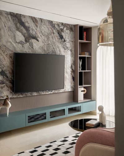 Living room with stone-clad tv wall, fluted panel, blue console, and sheer curtain window