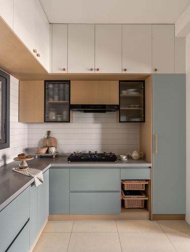 L-shaped kitchen with sage-green cabinetry, wood accents, fluted glass upper cabinets and black hob