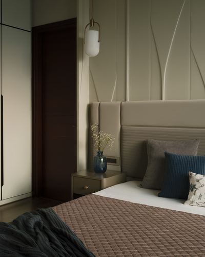 Bedroom corner with tufted headboard, fluted wall panels, and brass pendant light