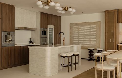 Luxury kitchen with dark wood cabinetry, ribbed stone island, brass chandelier and cane-textured accent door