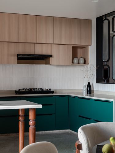 Kitchen with wood upper cabinets, teal lower cabinets, textured tile backsplash and gas hob