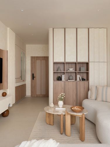 Beige living room with fluted panelling, wood-and-stone nesting tables and a bouclé sofa