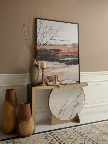 Console vignette with abstract art, marble medallion table, wooden vases and brass legs