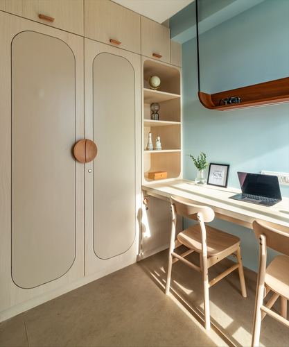 Sunlit study nook with arched wardrobe doors, leather knob, open shelving and built-in desk