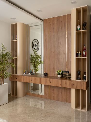 Foyer console with mirror, wood panelling, curved beige shelving and marble flooring