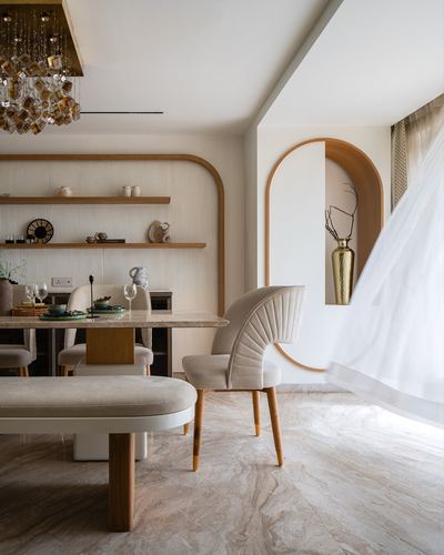 Dining nook with fluted arch niche, sheer curtain, marble table and fan-back upholstered chair