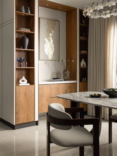 Wood-panelled dining nook with open shelving, artwork niche, marble table and cane-back chair
