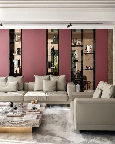 Living room with maroon wall niches, beige sectional sofa and marble coffee table