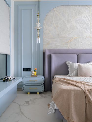 Blue paneled bedroom with lavender upholstered bed and marble arched headboard wall
