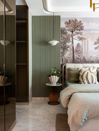 Bedroom corner with fluted green wall, pendant light, round side table, and mural-backed bed