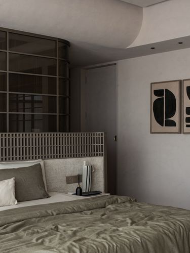 Bedroom with olive linen bed, lattice headboard, curved glass partition and abstract wall art