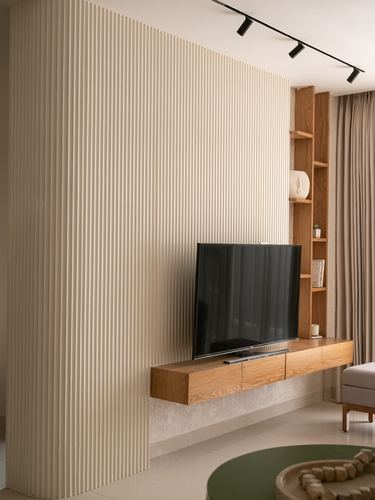 Living room with fluted cream wall, floating wood TV console, and corner shelving unit