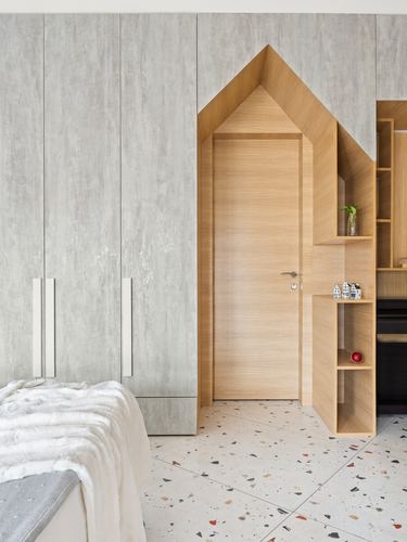 Bedroom with house-shaped wooden door frame, grey wardrobes, and terrazzo floor