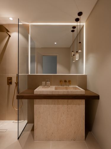 Bathroom vanity with travertine base, wood countertop, stone sink and backlit mirror