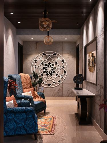 Narrow marble corridor with teal wingback chairs, mandala wall art, and pendant lights