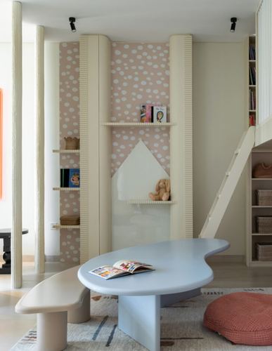 Child's room with fluted columns, polka-dot niche, organic blue table and ladder to loft bed