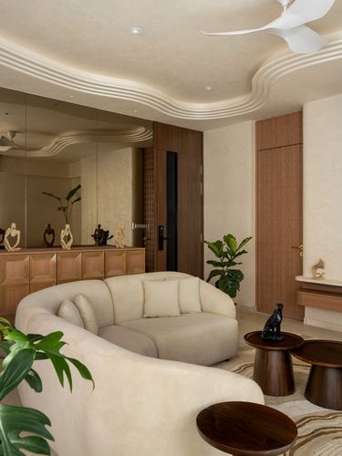 Curved beige sofa beneath a sculpted wavy ceiling with mirrored wall and wooden accents
