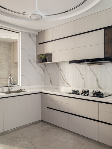 Modern L-shaped kitchen with marble-look backsplash, black hob, and curved ceiling detail