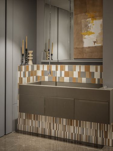 Bathroom vanity with mosaic tiled base, dark trough sink, mirror and abstract art above