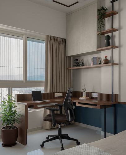 L-shaped wooden study desk by window with ladder shelf and blue accent wall