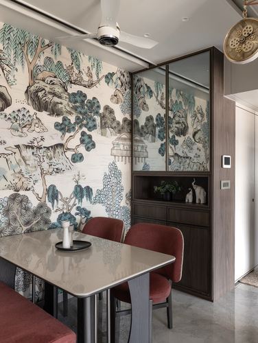 Dining nook with hand-illustrated mural wallpaper, terracotta chairs, and mirrored dark wood cabinet