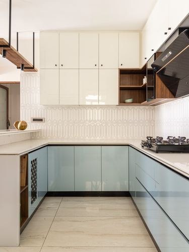 U-shaped kitchen with white upper cabinets, pastel blue lower units, and wood open shelving