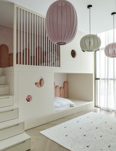 Children's built-in bunk nook with scalloped pink panels, porthole windows, and layered paper lantern pendants