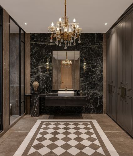 Dark marble powder room with crystal chandelier, vessel sink, and checkerboard marble floor