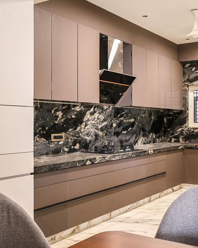 Modern kitchen with mauve glossy cabinets, dark veined stone backsplash, and marble flooring