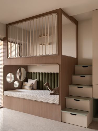 Built-in bunk bed nook with rope railing, round mirrors, and a staircase of storage drawers