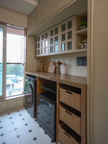 Mumbai kitchen utility nook with glass cabinets, stone counter, washing machine and wicker drawer storage