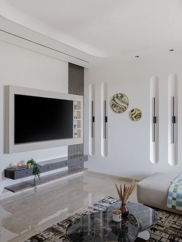 Living room with wall-mounted TV panel, floating console, and glowing vertical wall lights on curved wall