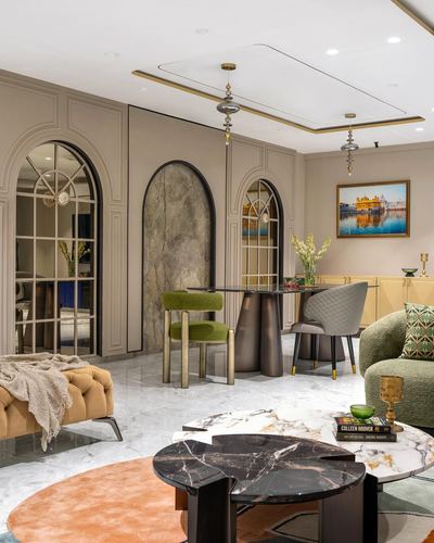 Living room with arched mirrored niches, stone panel, marble floor, and layered coffee tables
