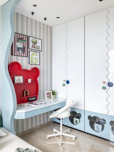 Child's study nook with red bear-shaped shelf, blue desk and zigzag wardrobe doors