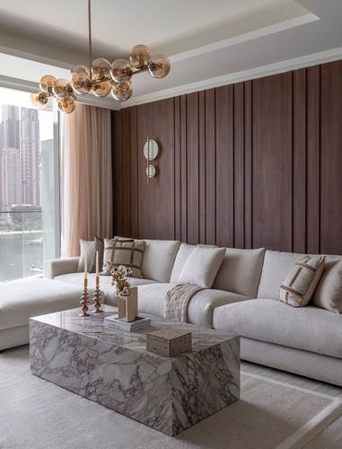 Living room with fluted wood wall, cream sectional sofa, and marble coffee table overlooking city skyline
