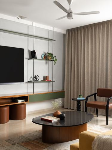 Living room with floating tv console, hanging shelves, oval coffee table and leather armchair