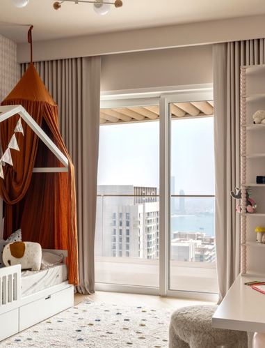 Child's bedroom with house-frame canopy bed, sheer curtains, and floor-to-ceiling city view.