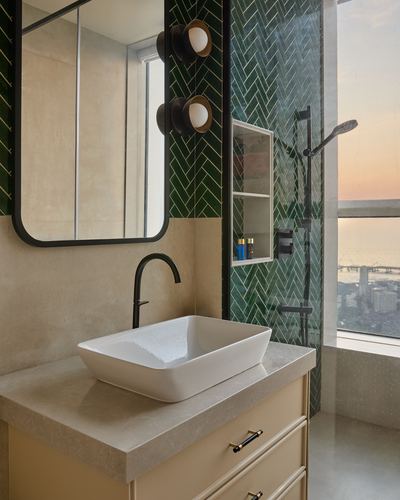 Bathroom vanity with vessel sink, black mirror, and green herringbone tiled shower with city view
