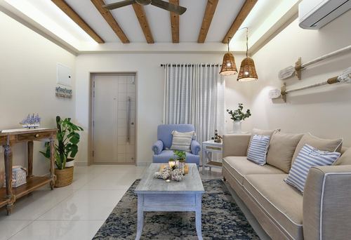 Coastal-boho living room with beige sofa, blue armchair, exposed beams and rattan pendants