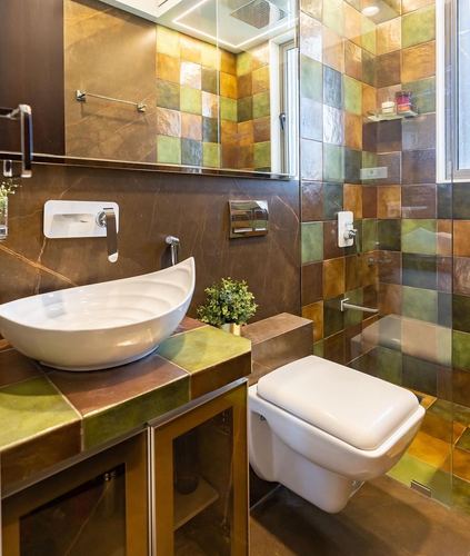 Bathroom with boat-shaped vessel sink, wall-hung toilet, and multicolor glazed tile walls