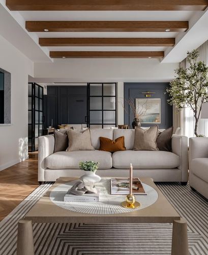 Living room with beige sofa, wood-beamed ceiling, and navy paneled wall beyond glass partition