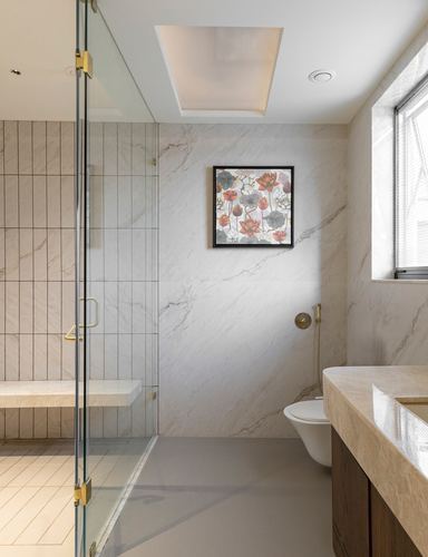 Marble bathroom with glass shower, floral artwork, wall-hung toilet and wood vanity, softly lit by window and ceiling panel