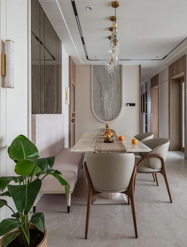 Dining table with marble top, arched stone wall niche, and cluster brass pendant lights