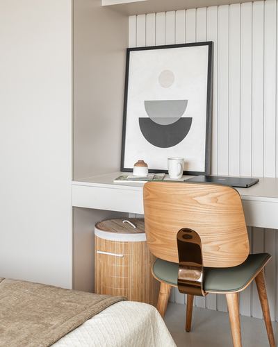 Study nook with fluted paneling, wooden chair, desk, and abstract print in beige tones