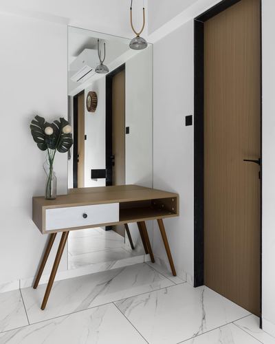 Entryway console with mirror, wooden door, and marble-look floor in a minimal foyer