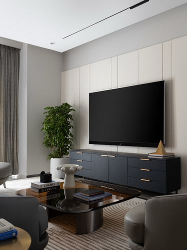 Living room with fluted panel wall, wall-mounted tv, dark sideboard, oval coffee table and armchairs