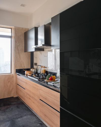 Modern kitchen with black gloss cabinets, wood drawers, stone backsplash and city view window