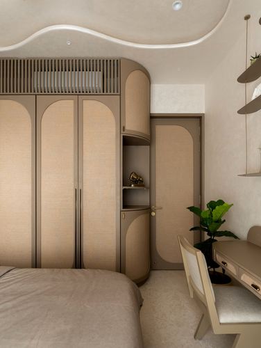 Bedroom with arched cane wardrobe doors, curved ceiling detail, and a small desk with plant