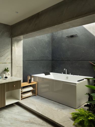Freestanding tub against dark stone wall beside open planted courtyard niche