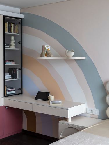 Kids study nook with rainbow arch mural, floating shelf and built-in desk